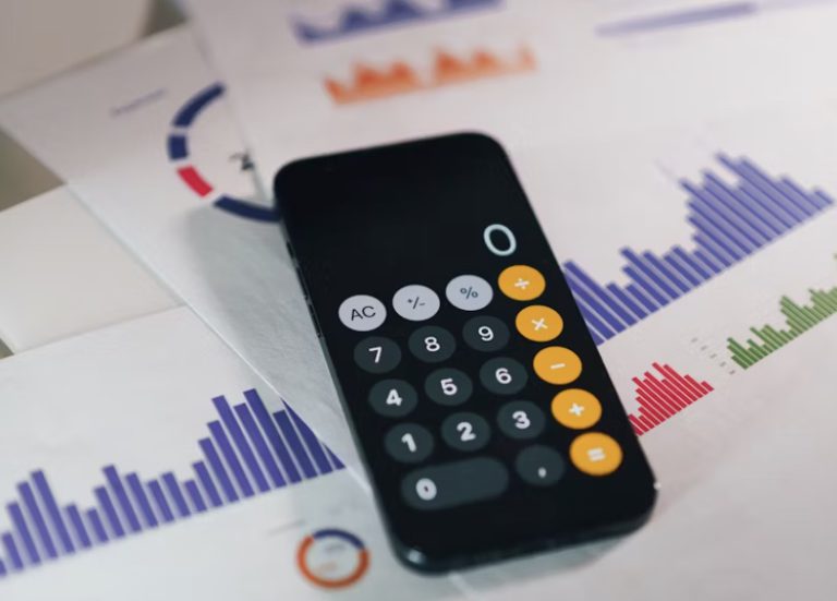 a calculator on top of a stack of paper for analysis