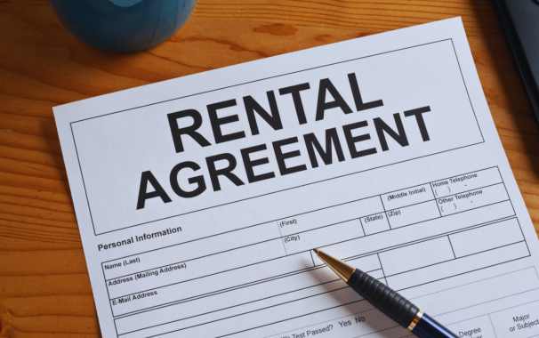 a pen on a rental agreement contract