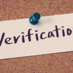 a sign that says verification on a bulletin board