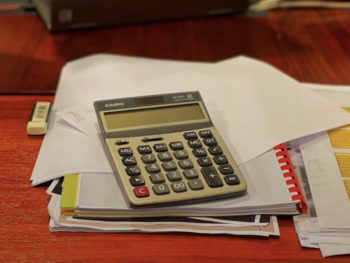 a calculator on a pile of paper